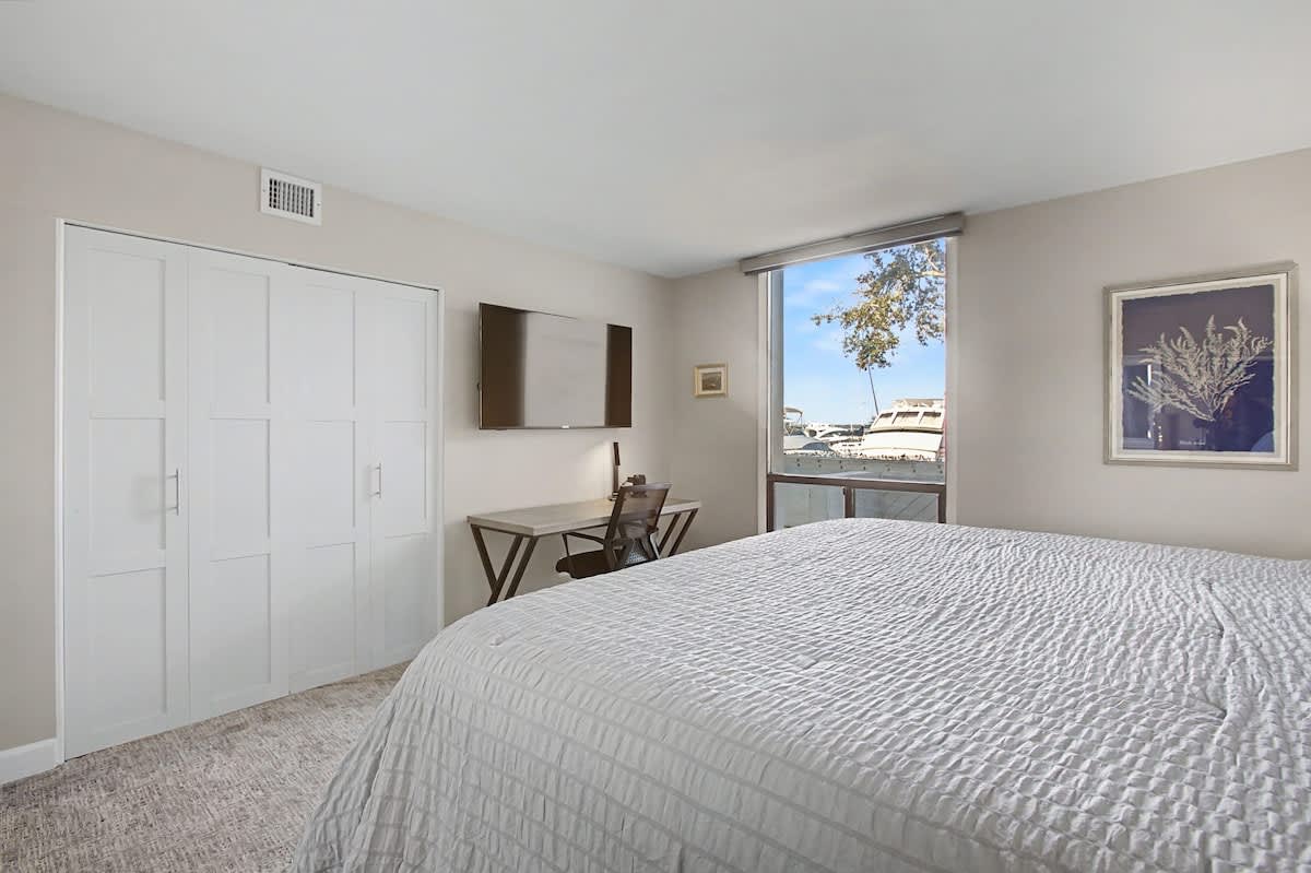 Wake up to natural light streaming through your window in this serene bedroom with ample storage and a dedicated workspace for your comfort.