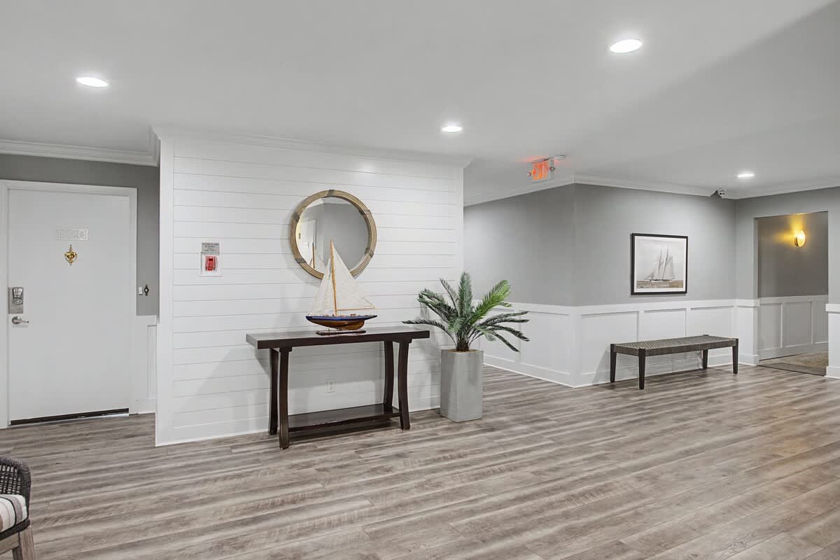 Relax in this elegantly designed common area with coastal-inspired décor, comfortable seating, and warm lighting for your perfect getaway.