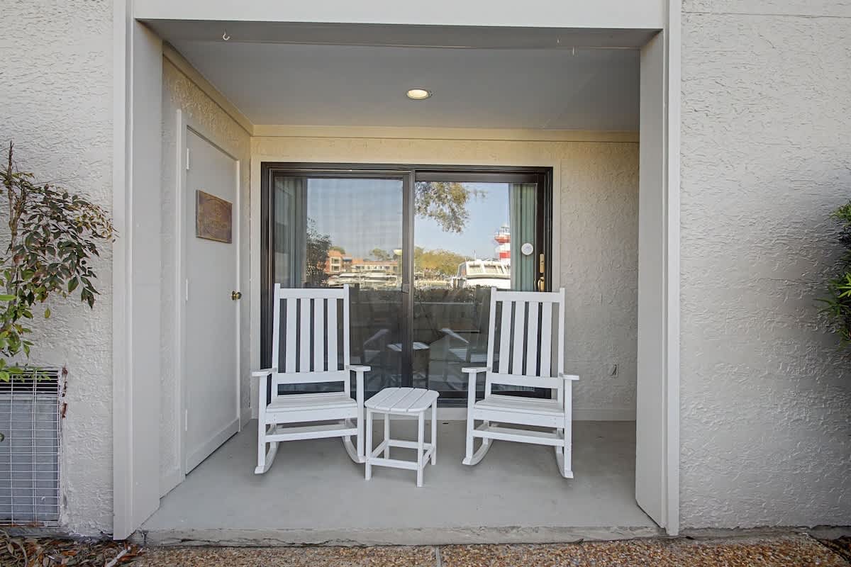 Your private patio retreat awaits with cozy rocking chairs where you can unwind while enjoying peaceful views.