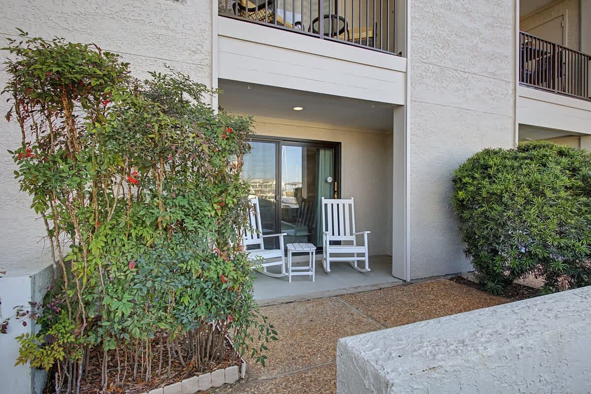 Your private patio offers a peaceful retreat with comfortable seating where you can unwind outdoors, surrounded by thoughtful landscaping.