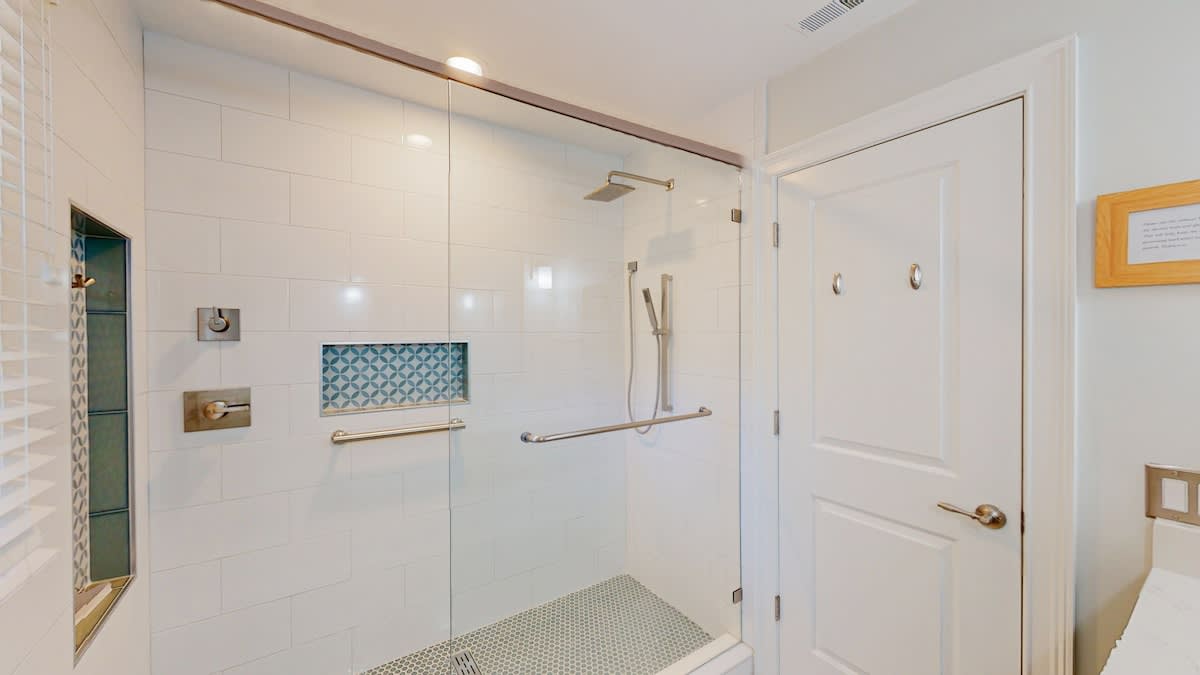 Your private spa-like bathroom features a spacious walk-in shower with rainfall head and elegant tilework for ultimate relaxation.