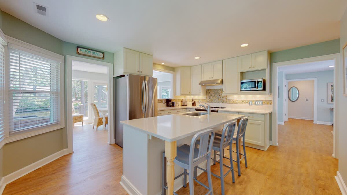 Your spacious kitchen awaits with gleaming countertops, modern appliances, and a welcoming island perfect for morning coffee or evening conversations.