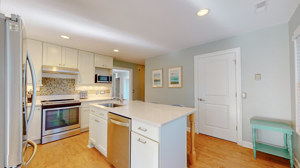 Your fully equipped kitchen features modern appliances, sleek countertops, and bright open design perfect for cooking memorable meals during your stay.