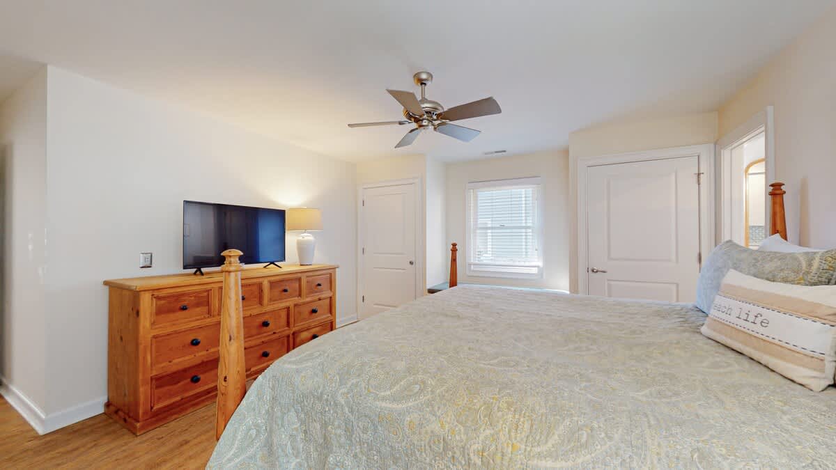 Wake up refreshed in your serene bedroom with comfortable bedding, ample storage, and gentle ceiling fan for perfect temperature control.