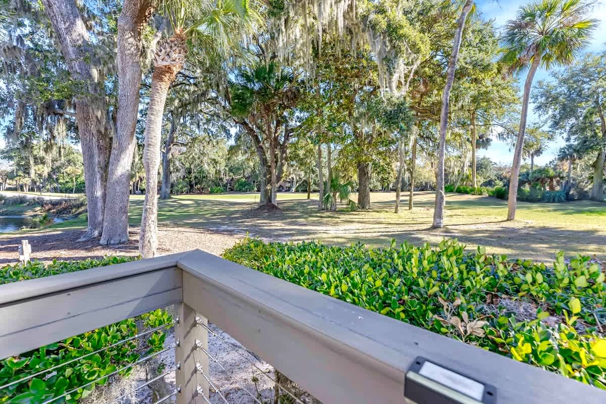 Peaceful golf course views with mature oak trees draped in Spanish moss create a serene backdrop for this Florida property.