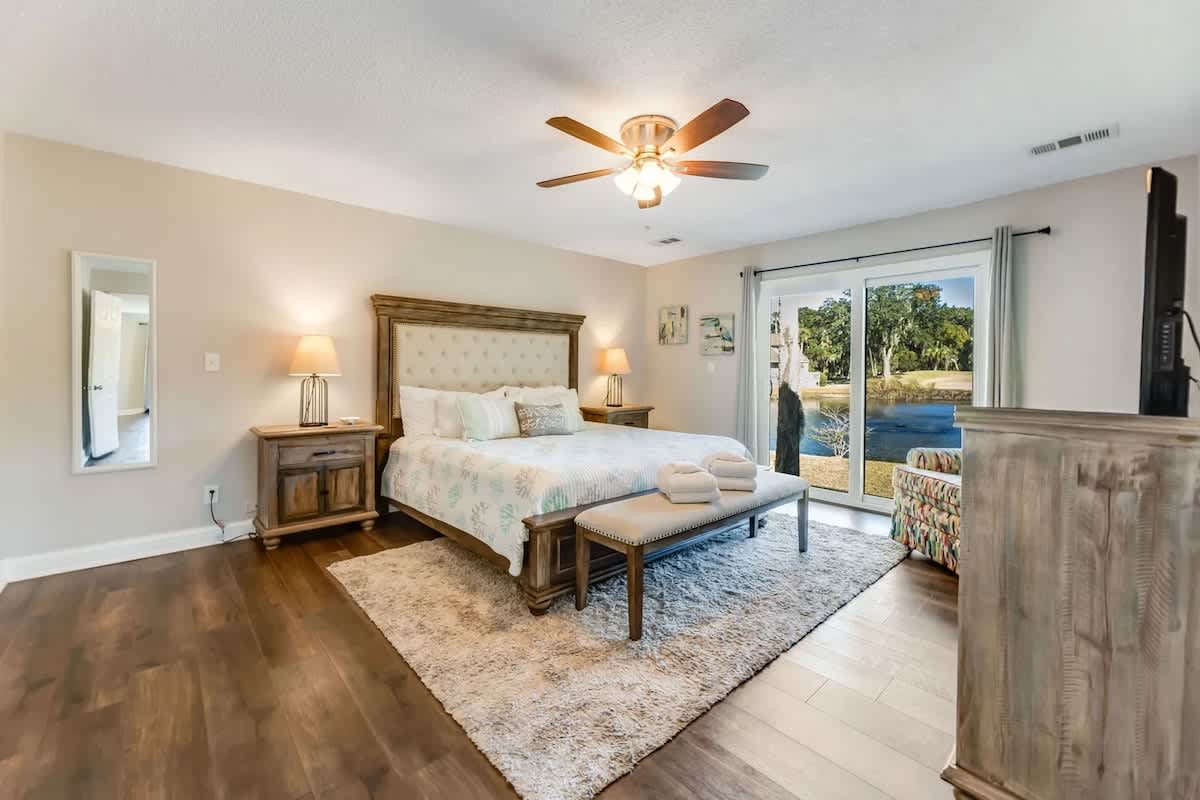 Wake up to serene water views from your beautifully appointed bedroom, complete with plush linens and elegant furnishings for ultimate comfort.