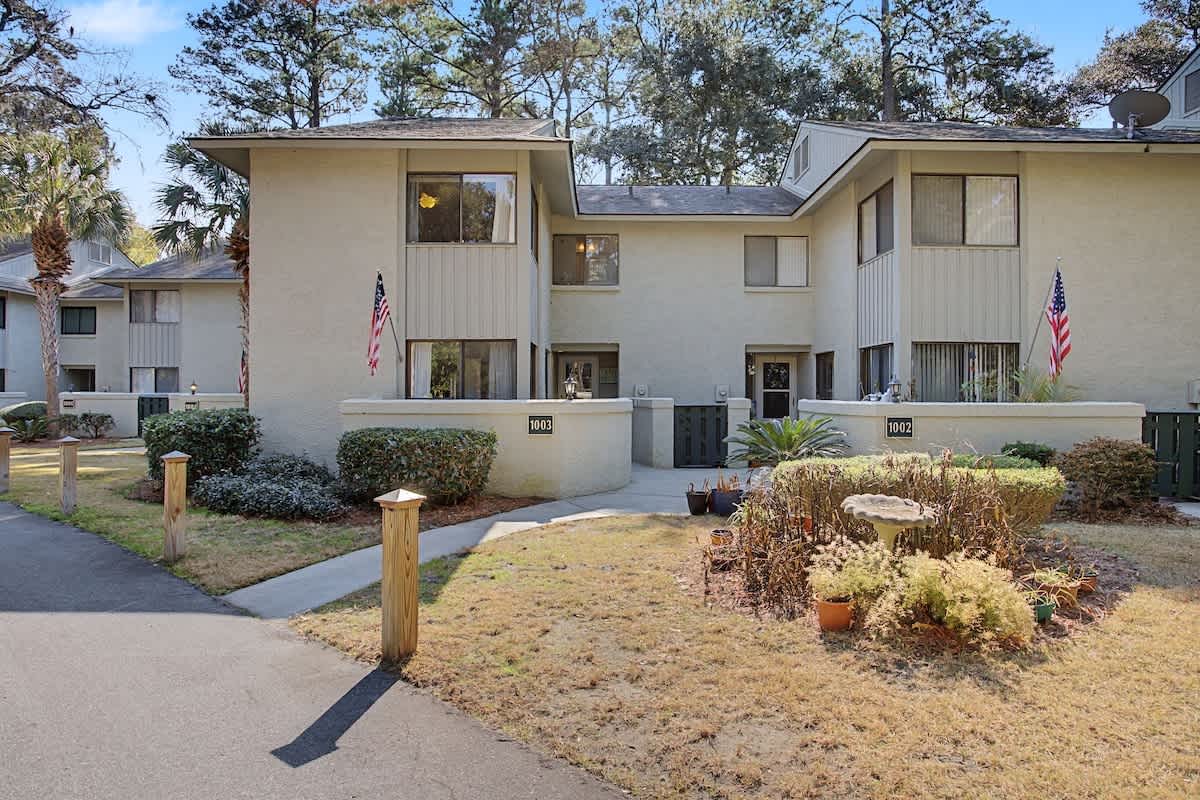 Modern townhome complex with landscaped grounds, mature trees, and convenient location in a peaceful residential community.