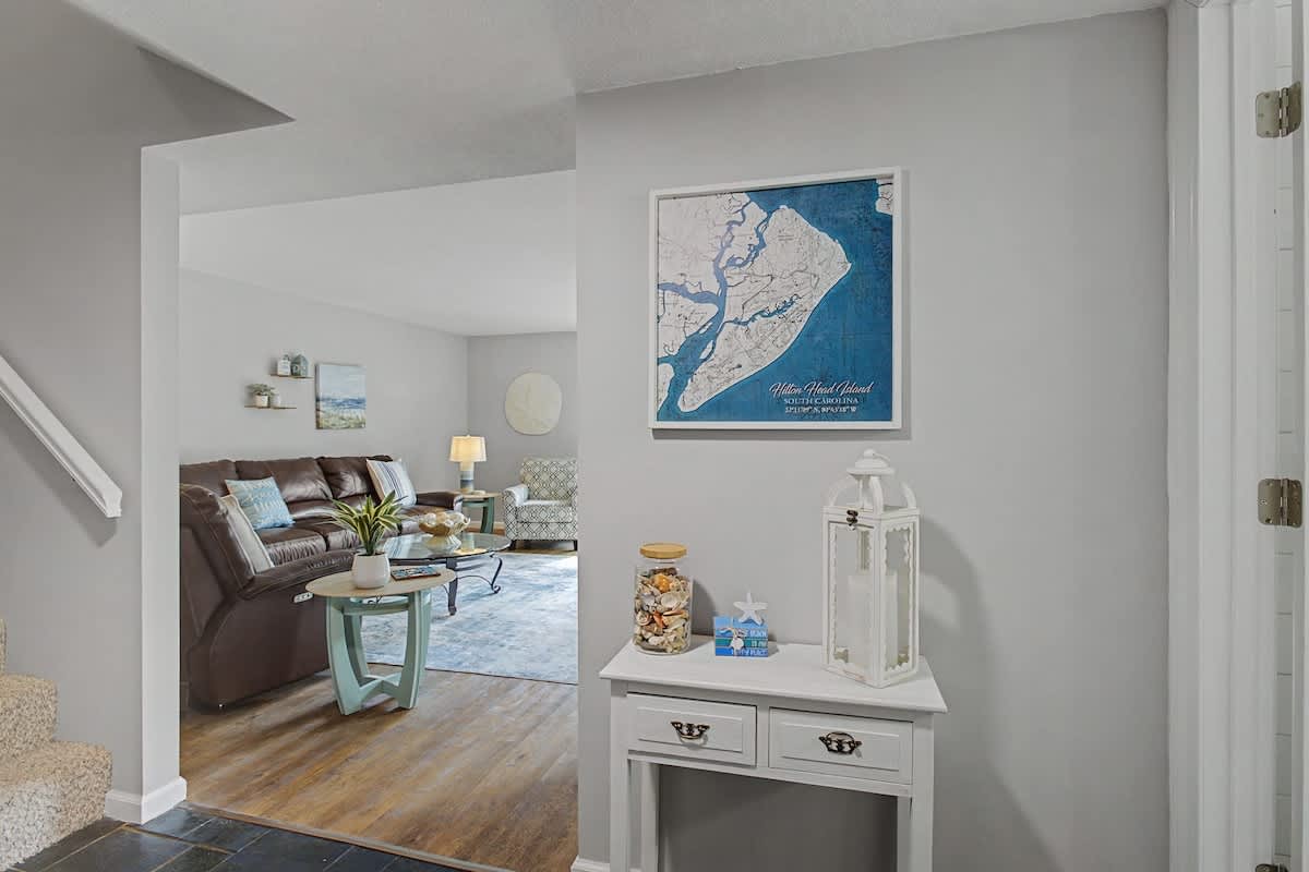 Step into your coastal retreat where nautical charm meets modern comfort in this inviting living space.