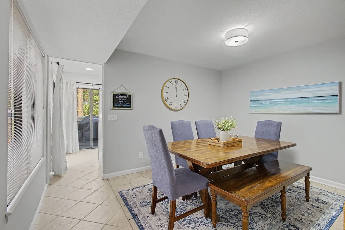 Your bright dining space features a rustic wooden table and comfortable seating, perfect for sharing meals and making memories.