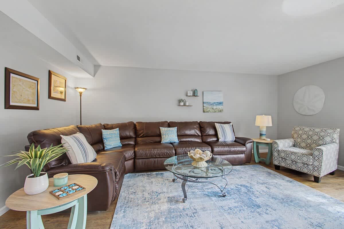 Sink into this plush leather sectional where your evenings unfold in comfort, surrounded by thoughtful touches and warm lighting.