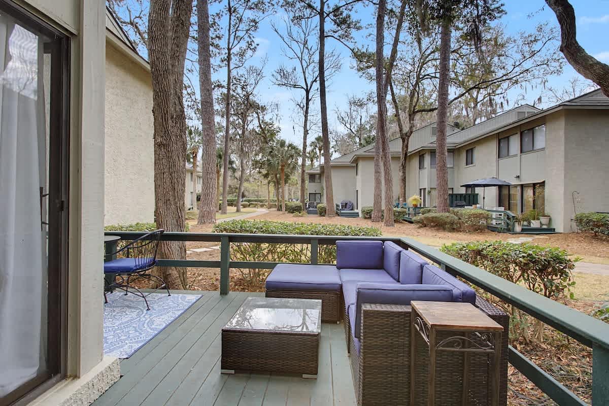 Unwind on your private deck with plush seating overlooking peaceful wooded grounds—your perfect spot for morning coffee or evening relaxation.