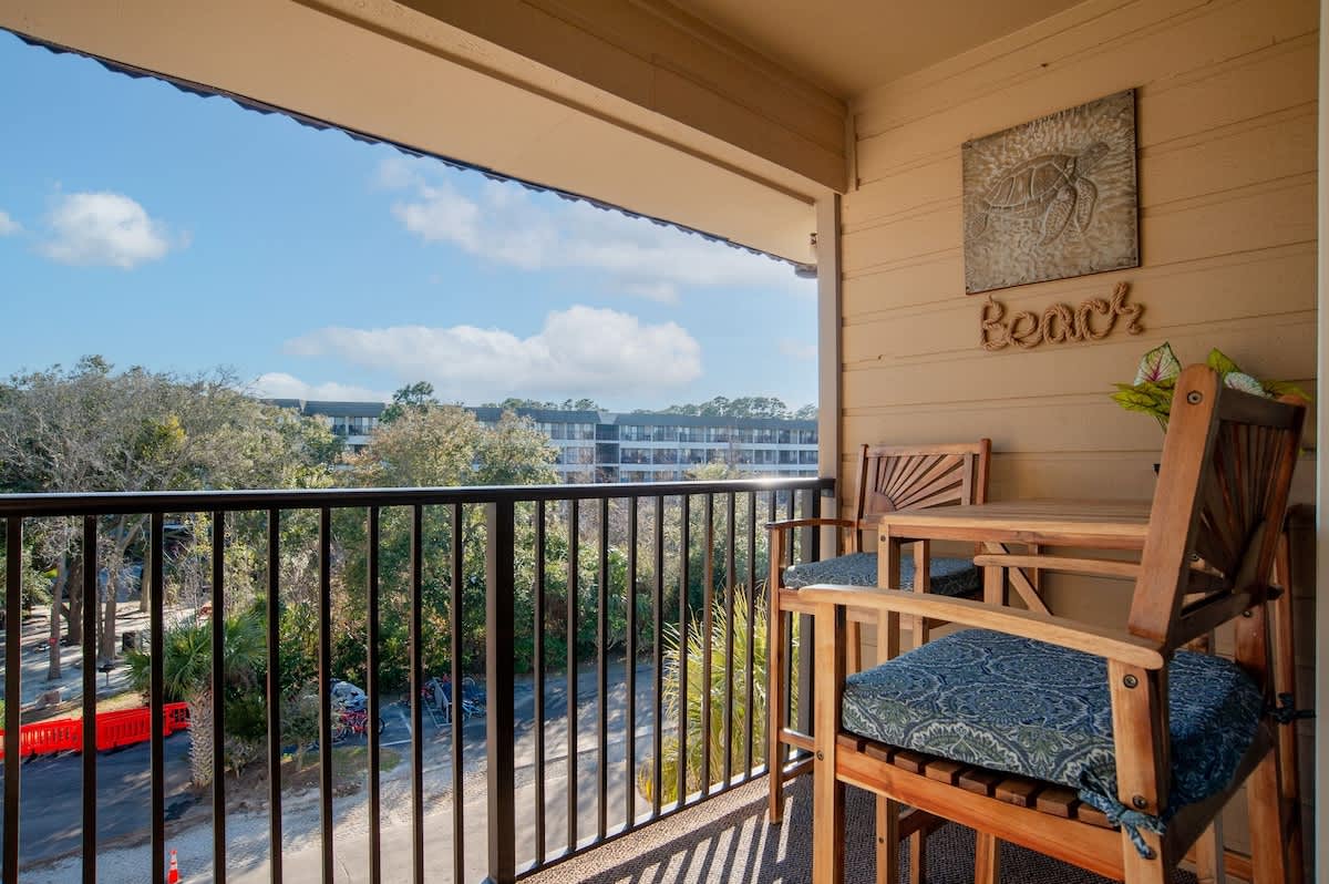 Unwind on your private balcony with comfortable seating and peaceful tree-lined views stretching across the neighborhood.