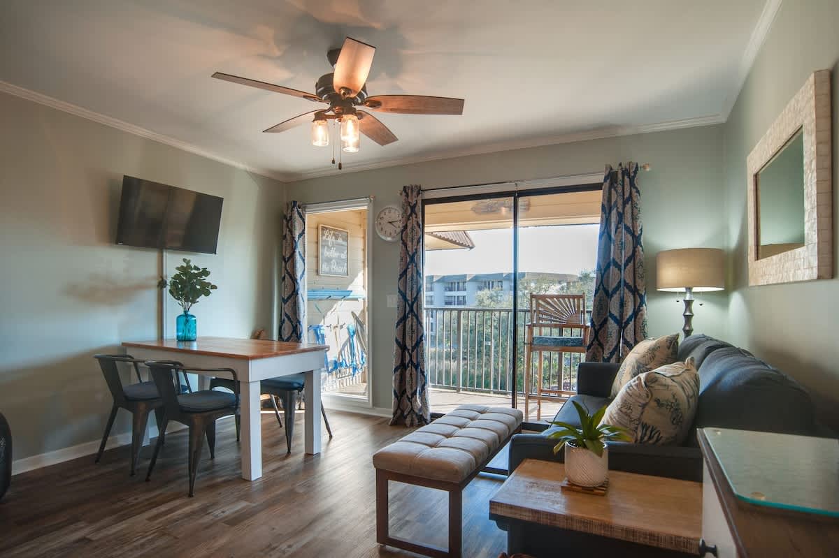 Your bright living space features modern furnishings and opens to a private balcony with lovely views—perfect for morning coffee or evening relaxation.