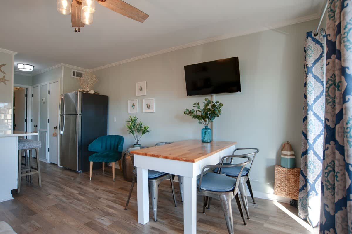 Gather around your stylish dining table for memorable meals in this beautifully furnished space with ocean-inspired touches.