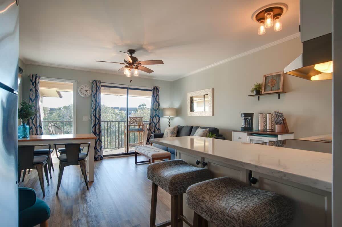 Your open-concept living space features a well-equipped kitchen, comfortable seating, and peaceful views from the private balcony.
