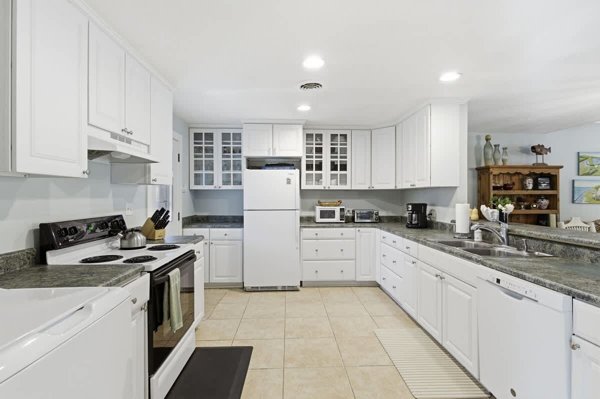 Your spacious kitchen features granite countertops, white cabinetry, and all the appliances you need for memorable meal preparation.