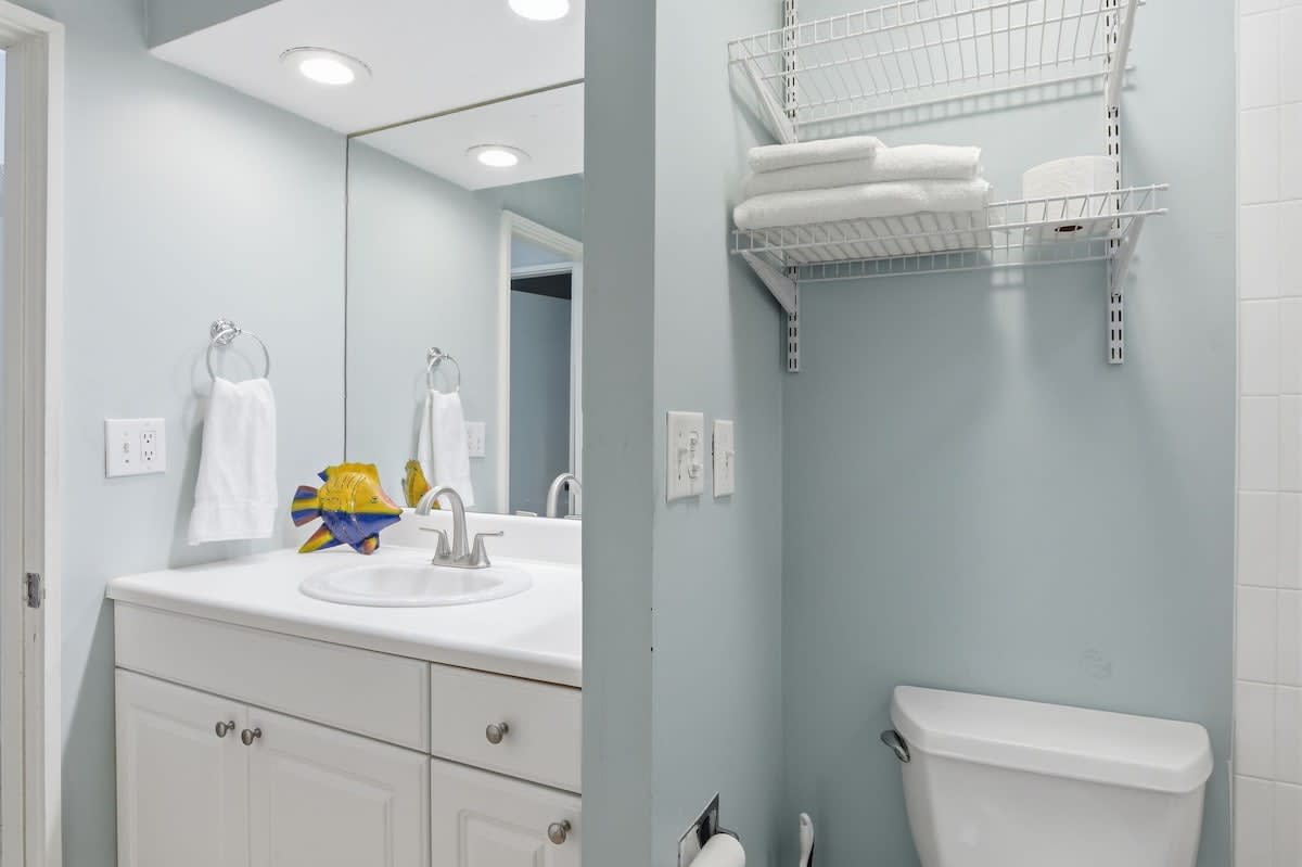 Refresh in your bright, modern bathroom with thoughtful storage and coastal charm—fluffy towels await your arrival.