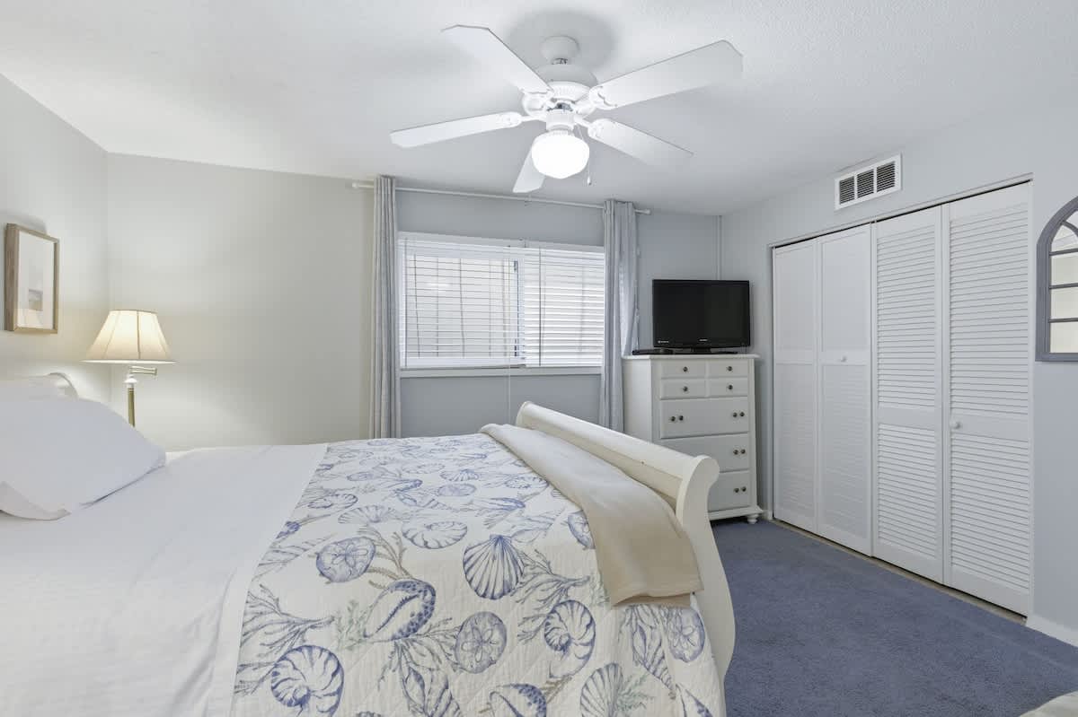 Drift off in your serene bedroom with coastal-themed linens, ceiling fan comfort, and ample closet space for all your getaway essentials.