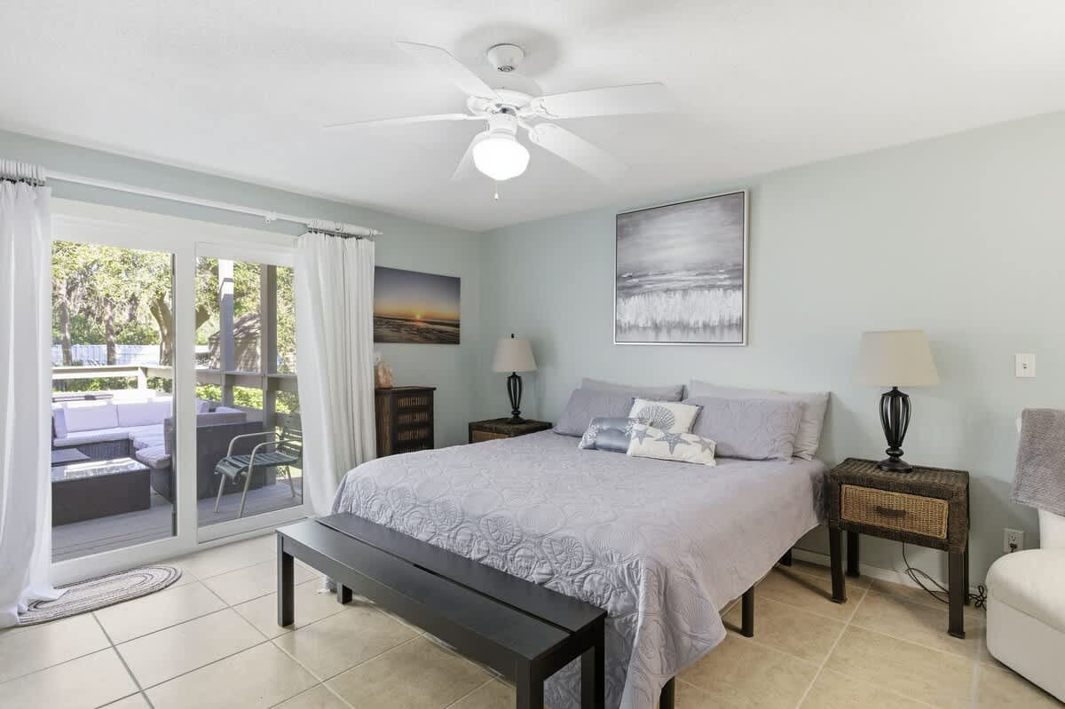 Your serene bedroom sanctuary features a plush king bed and opens to your private balcony where you can unwind with garden views.