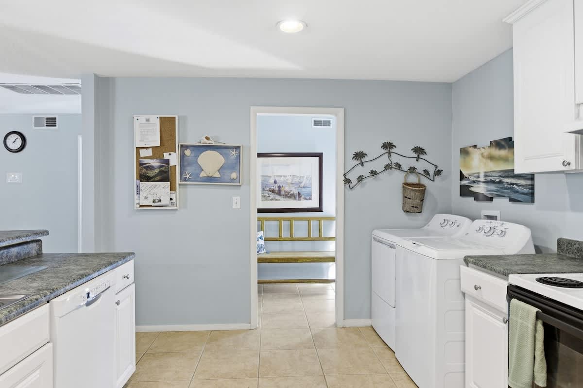 Your coastal retreat features a thoughtfully designed laundry space with modern appliances, making extended stays effortless and relaxing.