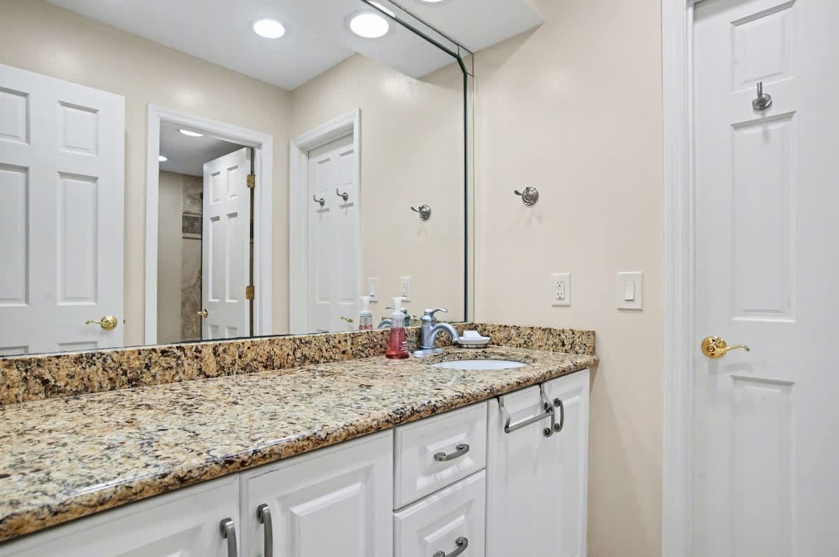 Freshen up in your elegant bathroom featuring granite countertops and modern finishes for a luxurious start to each day.