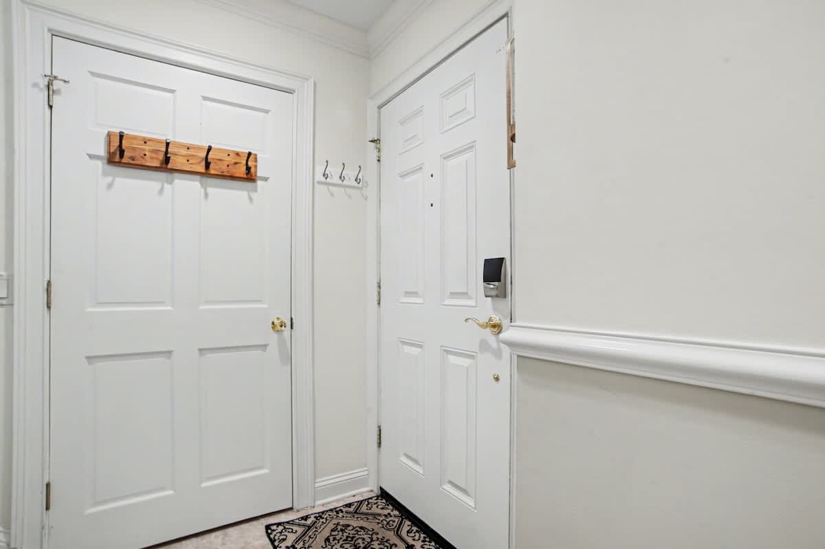 Step into your private entryway with convenient coat hooks and storage for all your belongings.