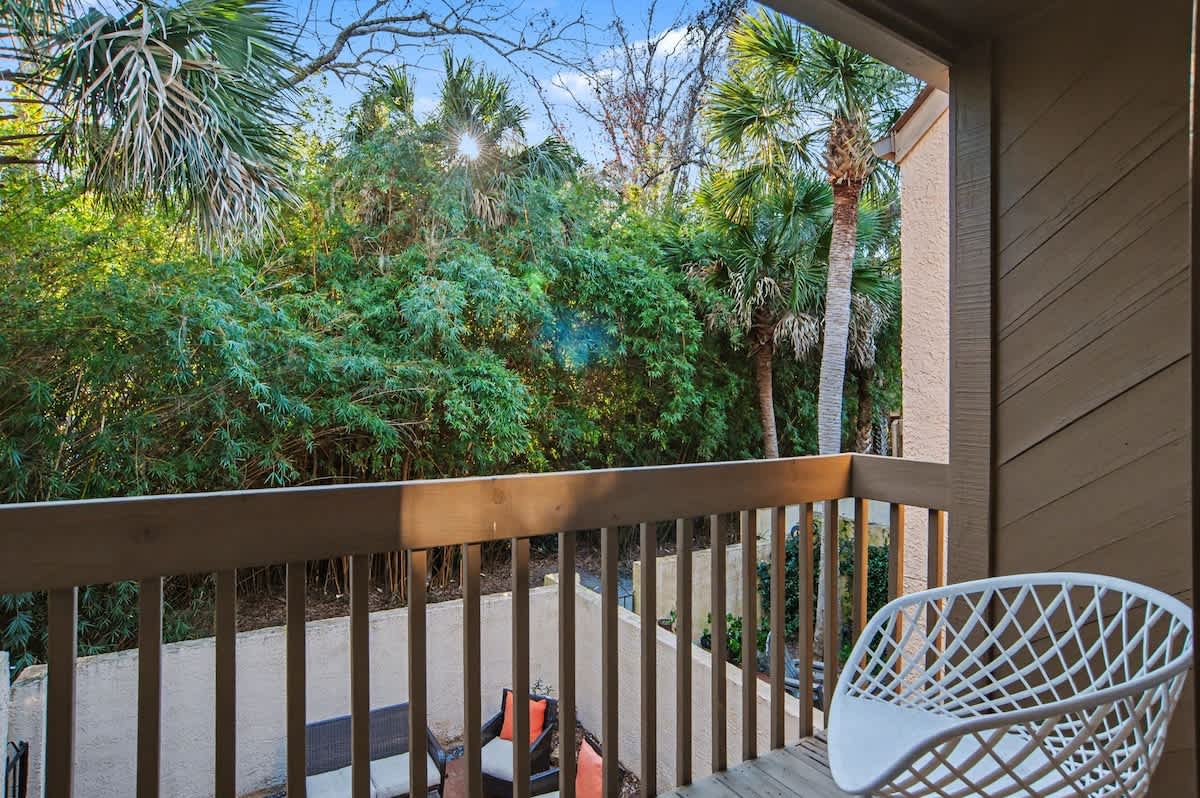 Step onto your private balcony and breathe in the tropical air surrounded by lush palms and greenery.
