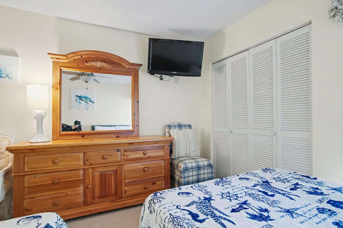 Relax in your coastal-themed bedroom with charming nautical touches, ample storage, and entertainment at your fingertips.