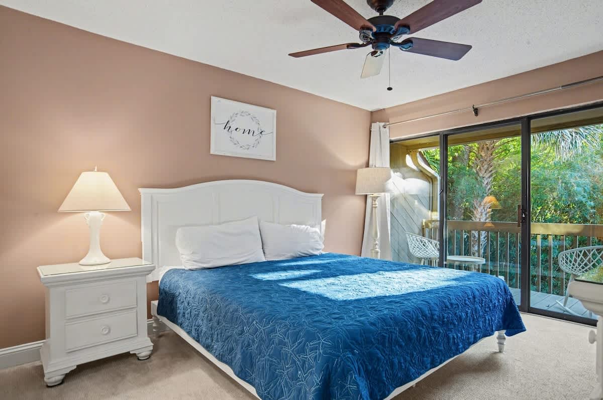 Drift off to peaceful sleep in your cozy bedroom, complete with tropical garden views and gentle ceiling fan breezes.