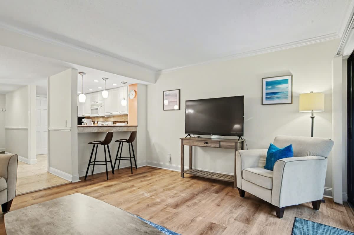 Unwind in your stylish living space with modern furnishings, flatscreen TV, and convenient kitchen bar seating perfect for morning coffee.