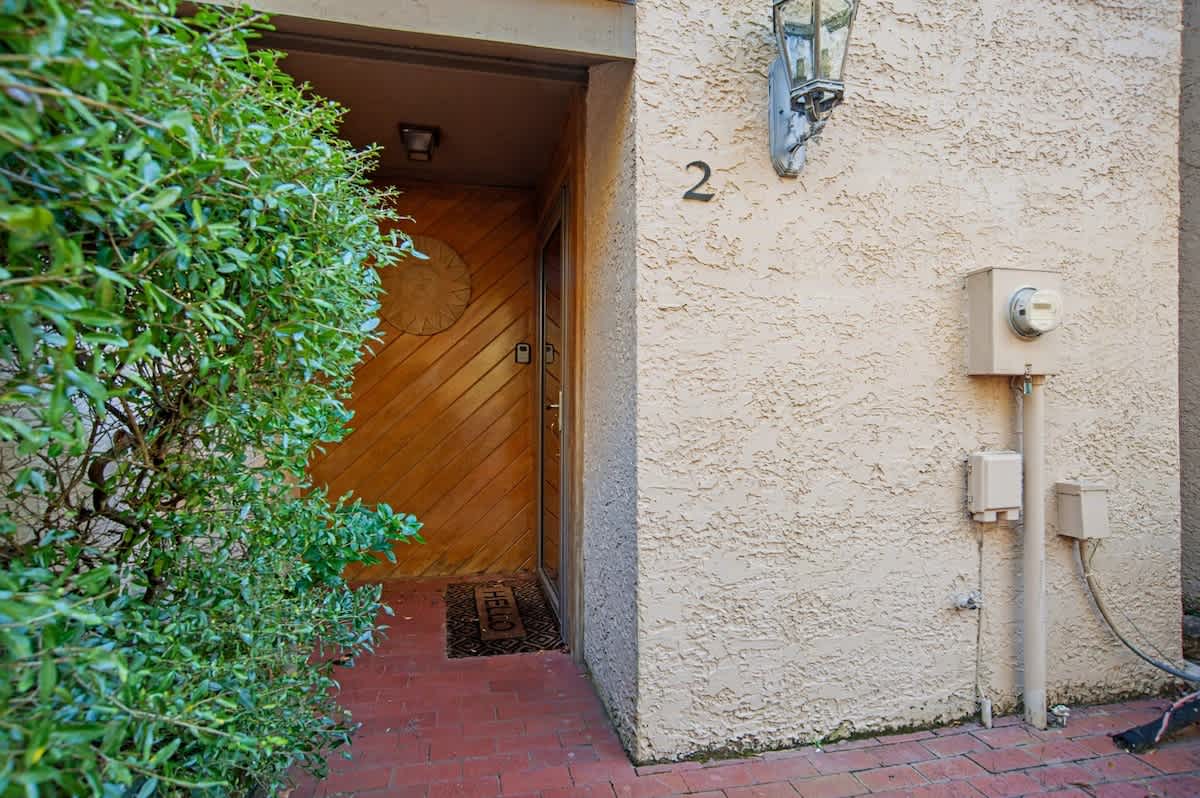 Property entrance marked as unit 2 with traditional lantern lighting and private brick pathway access.