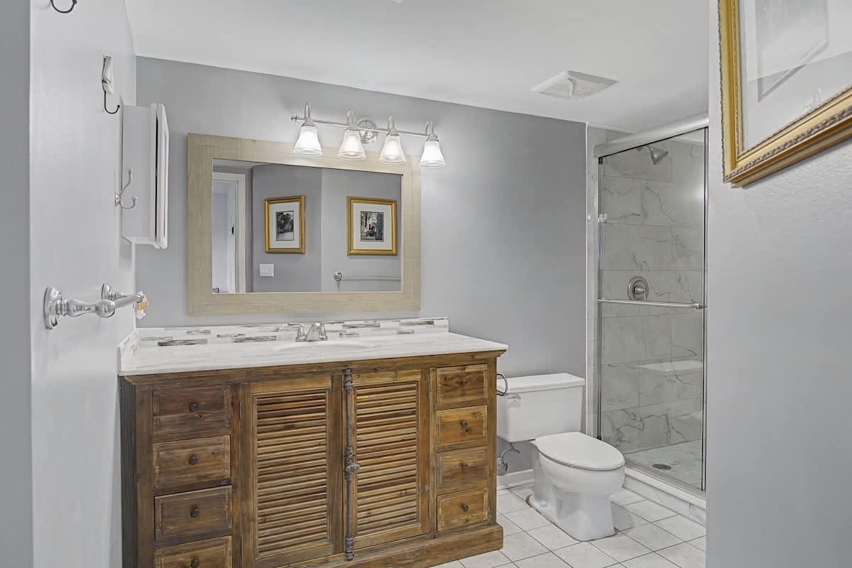 Your private bathroom features marble tile, elegant vanity, and spacious shower for relaxing after adventures.
