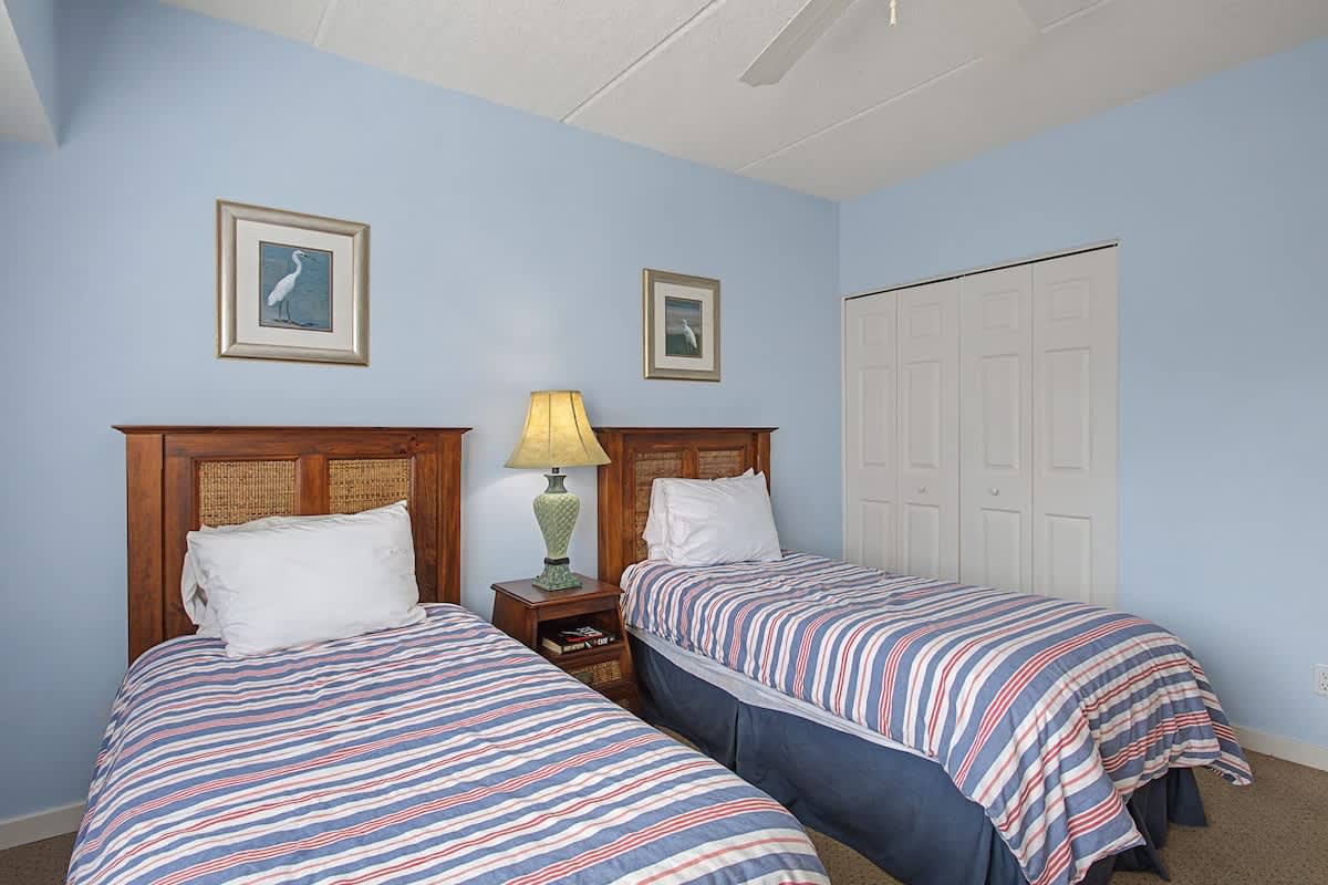 Unwind in this peaceful twin bedroom with crisp linens and coastal touches that create your perfect coastal retreat.