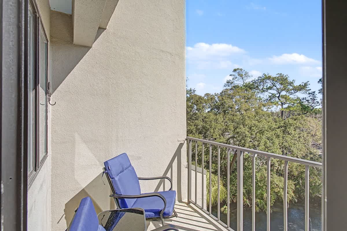 Step onto your private balcony and settle into comfortable seating while enjoying peaceful treetop views and fresh air.