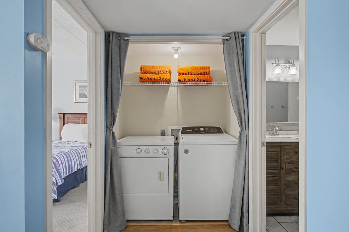 Your private laundry alcove keeps your clothes fresh, with convenient washer and dryer tucked neatly away behind soft curtains.