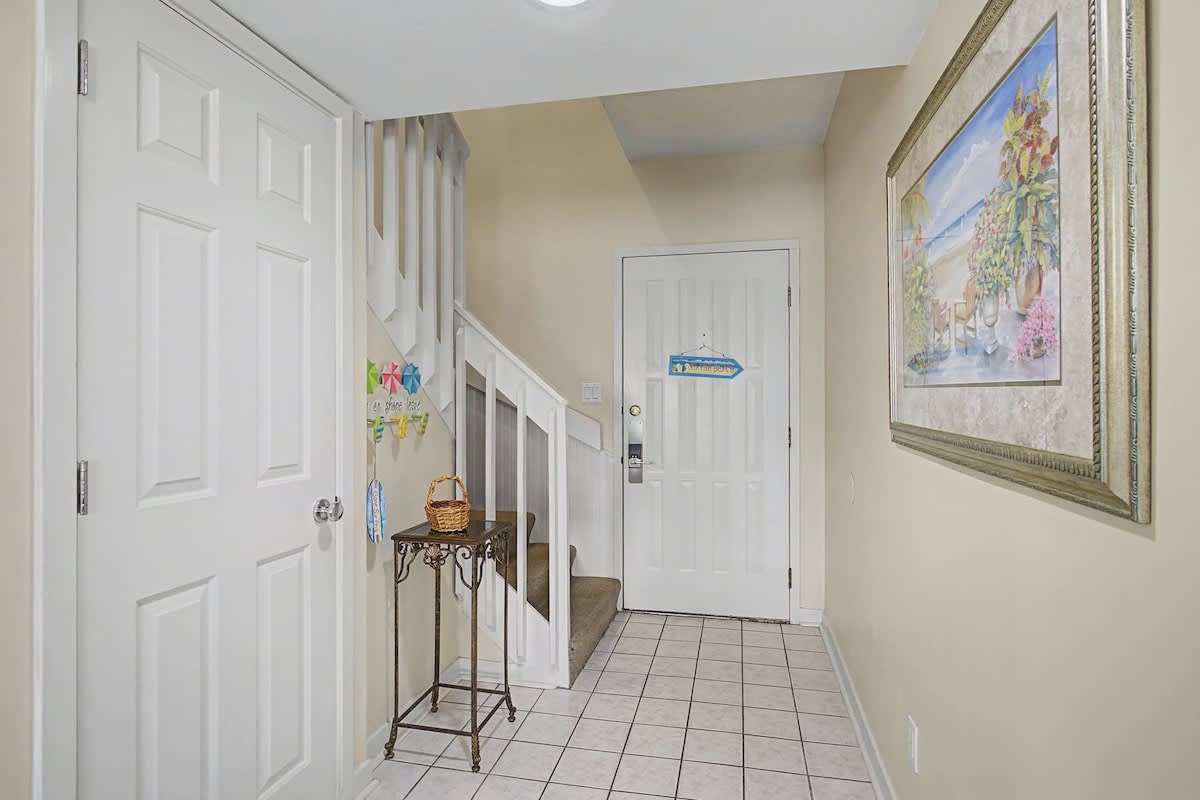 Step inside your welcoming entryway, where coastal artwork and thoughtful touches create an instantly relaxing atmosphere for your beach getaway.