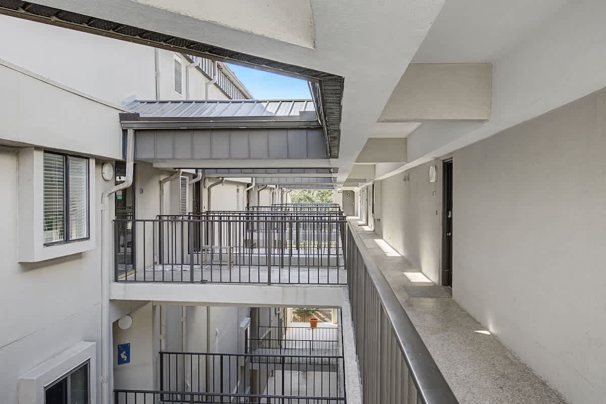 Multi-level property walkways connect your accommodations with modern railings and covered passages for comfort.