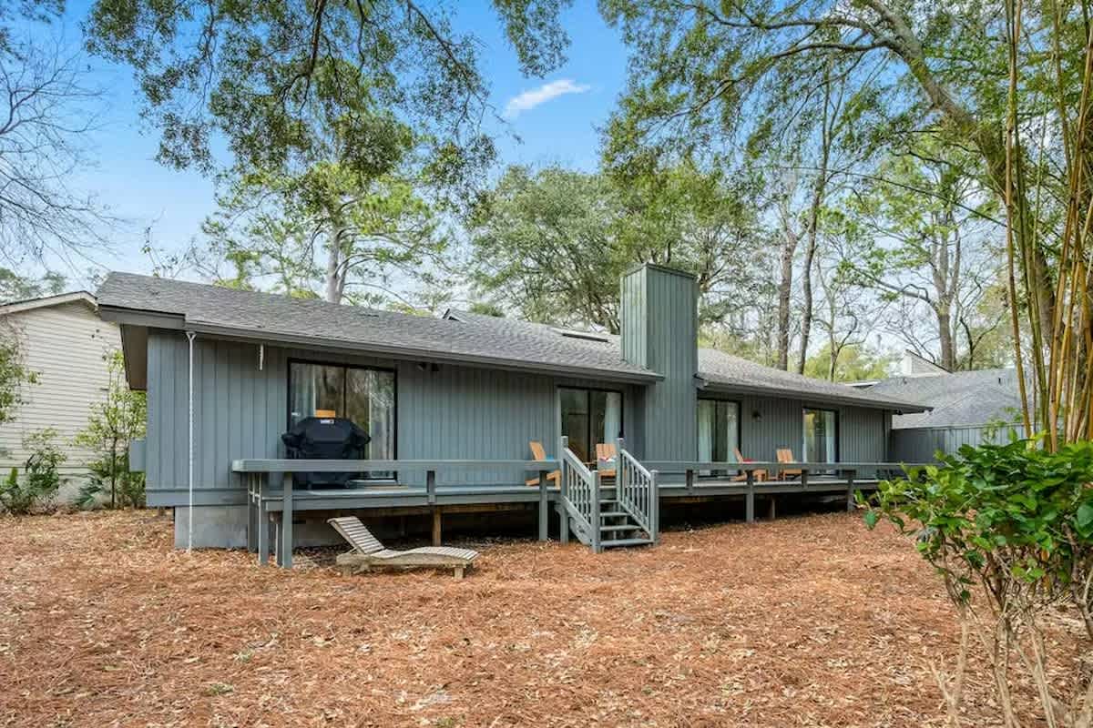 A peaceful retreat surrounded by mature trees and private outdoor space with deck seating and BBQ facilities.