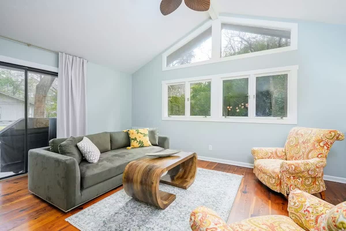 Relax in your bright living space with vaulted ceilings, cozy seating, and garden views through large windows.