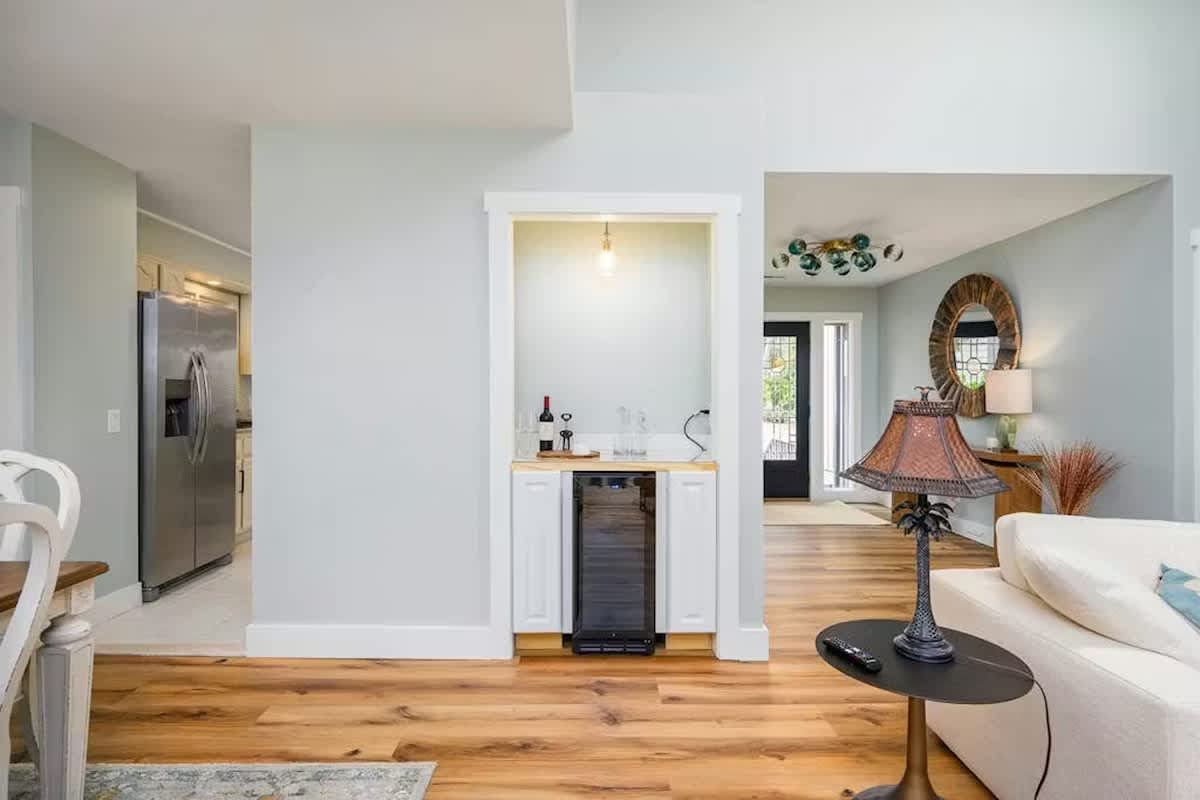 Your stylish open-concept living space flows seamlessly from lounge to kitchen, featuring warm hardwood floors and thoughtful details throughout.