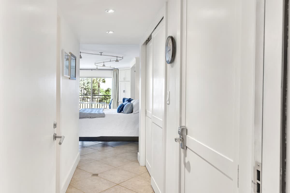 Step into your bright, modern retreat where the master bedroom awaits with a balcony view and coastal charm.