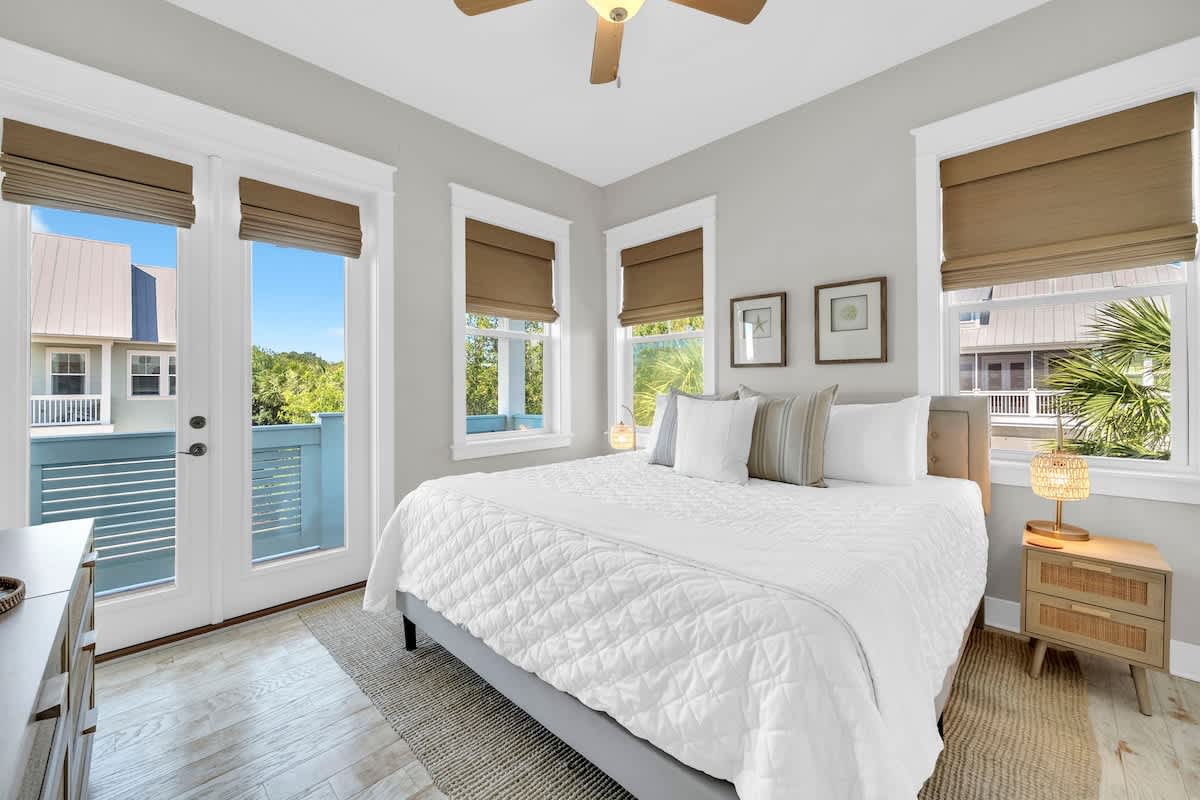 Guest bedroom featuring a king size bed and access to private porch.
