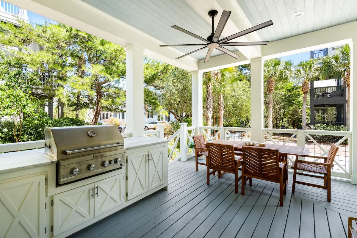 Outdoor grilling area includes a dining table with seating for 6 and a smart tv!