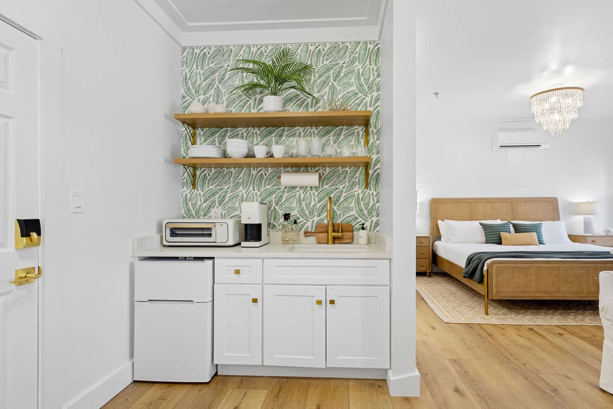 Kitchenette in condo features a toaster oven, Keurig coffee maker, mini fridge/freezer, and dishes!