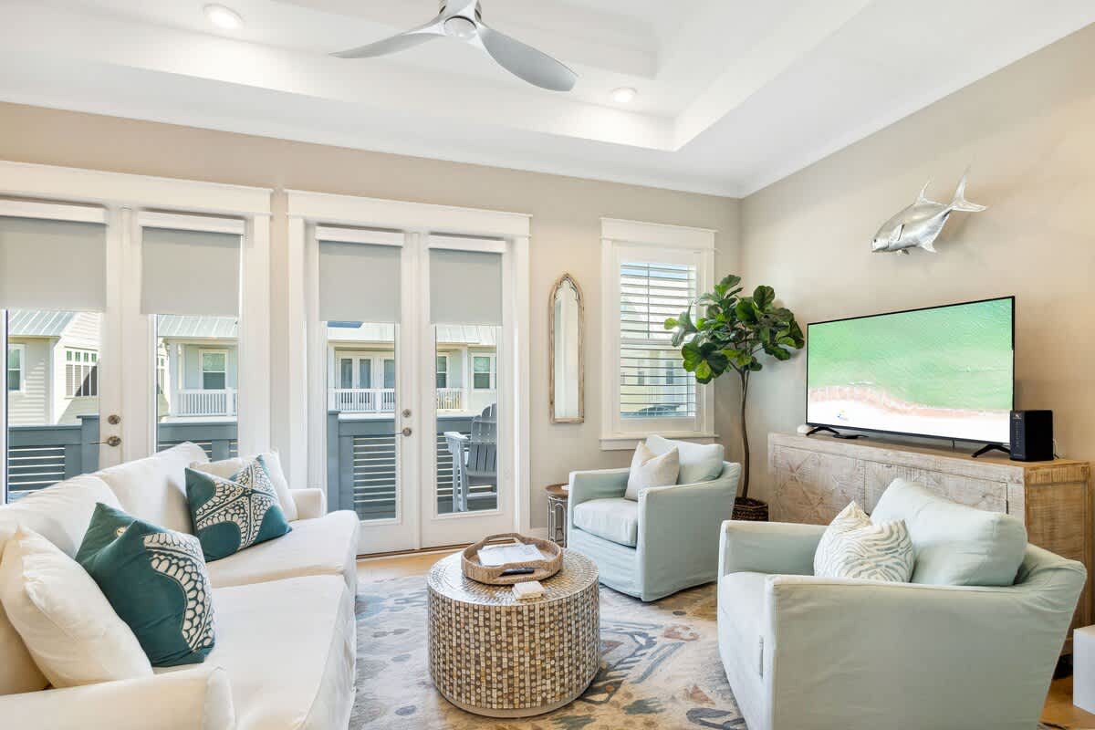 Living room features a smart tv and plenty of seating.