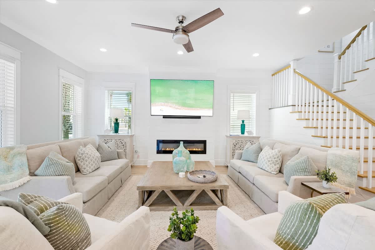 Living room includes plenty of seating for all, including rocking swivel chairs for lounging.