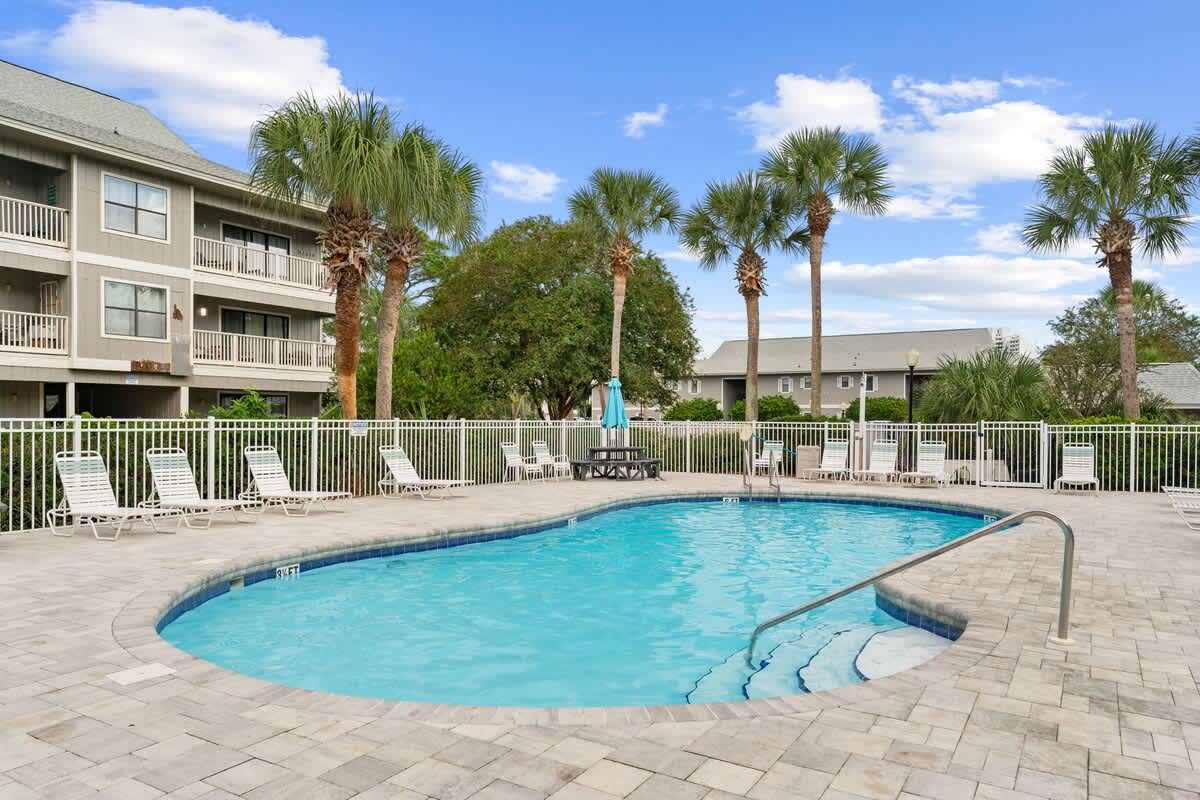 Community pool with lounge chairs.