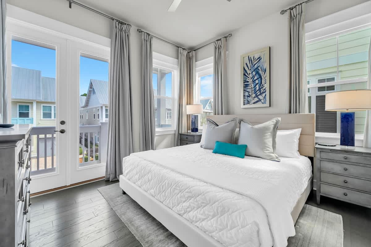 King bed in guest bedroom with private porch access