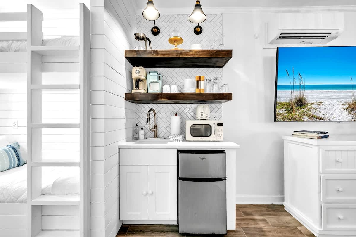 Kitchenette in condo features a toaster, Keurig coffee maker, mini fridge/freezer, and dishes!