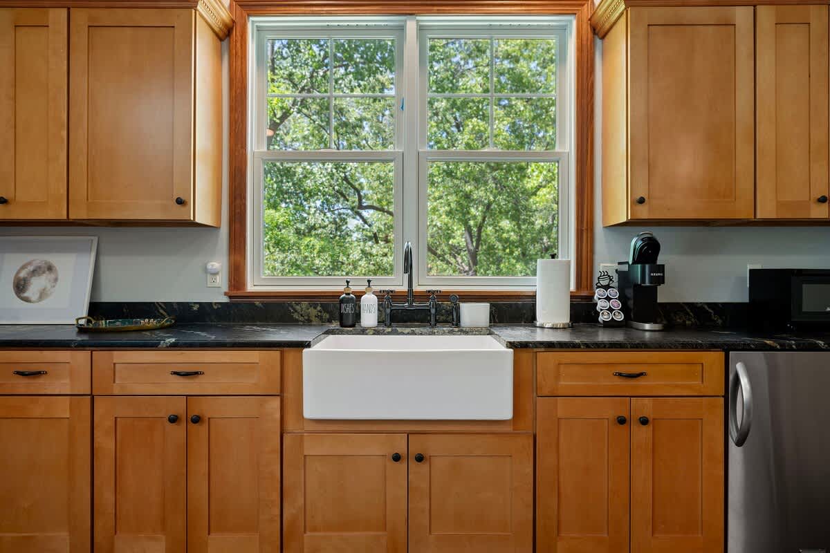 There's something so comforting about a kitchen with wooden cabinets and a timeless sink.
